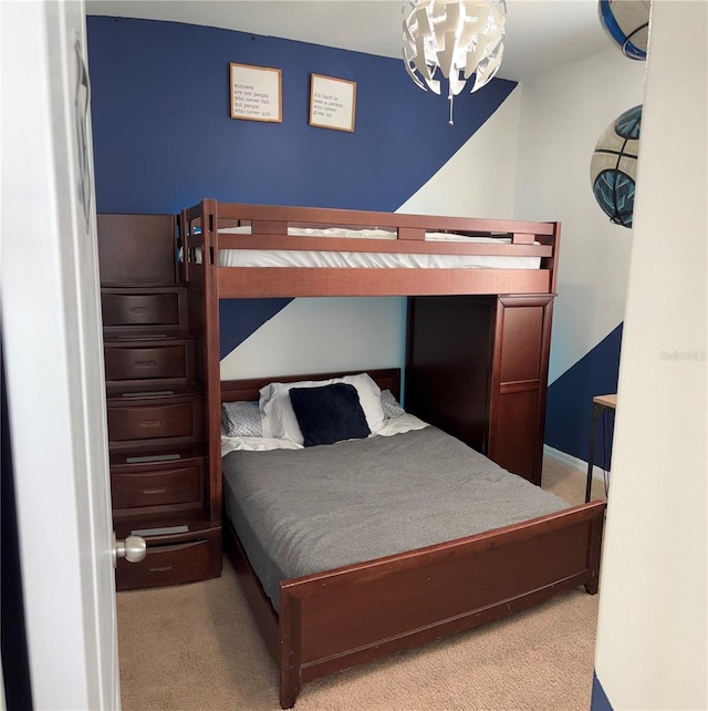 carpeted bedroom featuring a notable chandelier