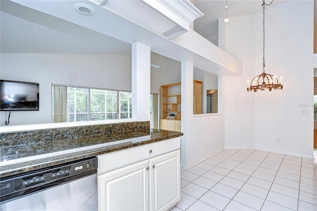 kitchen featuring light tile patterned floors, high vaulted ceiling, white cabinets, stainless steel dishwasher, and dark stone countertops