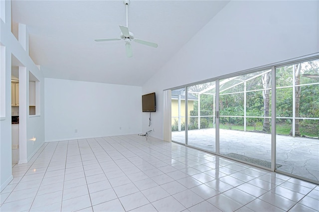 empty room featuring light tile patterned floors, high vaulted ceiling, and a ceiling fan