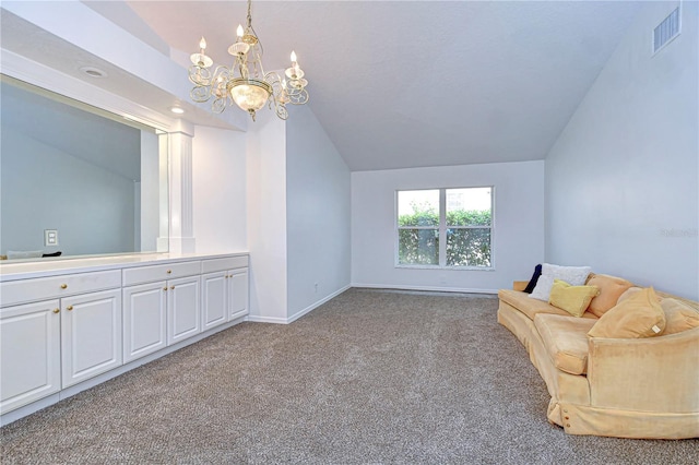 unfurnished room featuring baseboards, visible vents, an inviting chandelier, vaulted ceiling, and carpet floors