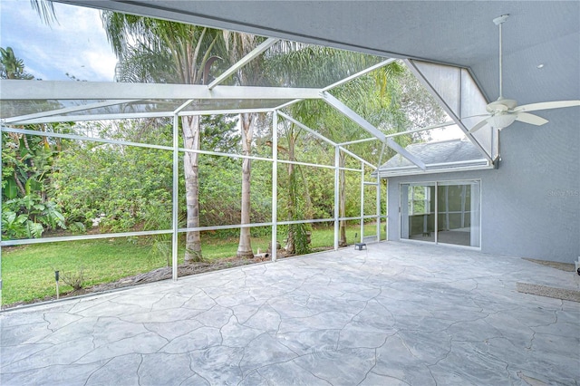 unfurnished sunroom featuring ceiling fan