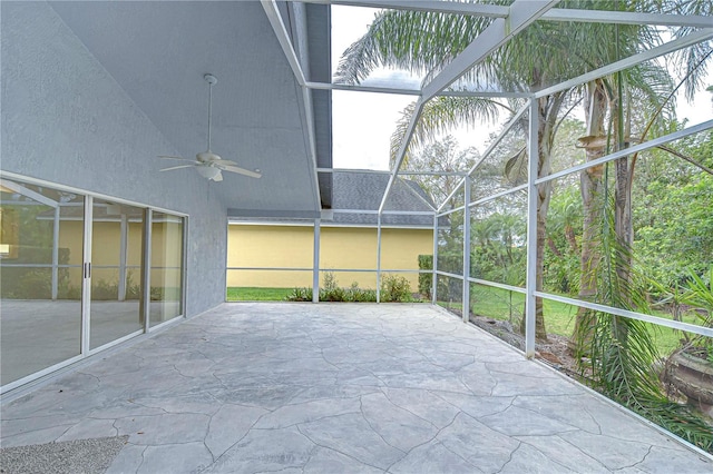 unfurnished sunroom featuring a ceiling fan