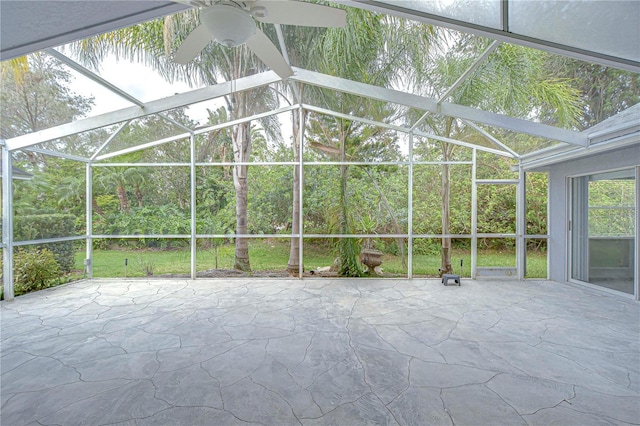 unfurnished sunroom with ceiling fan