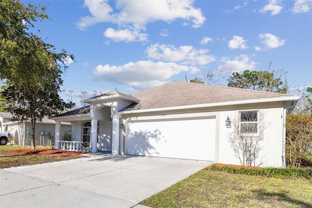 ranch-style home featuring driveway, an attached garage, roof with shingles, and stucco siding