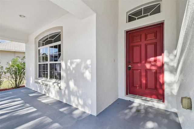 doorway to property with stucco siding