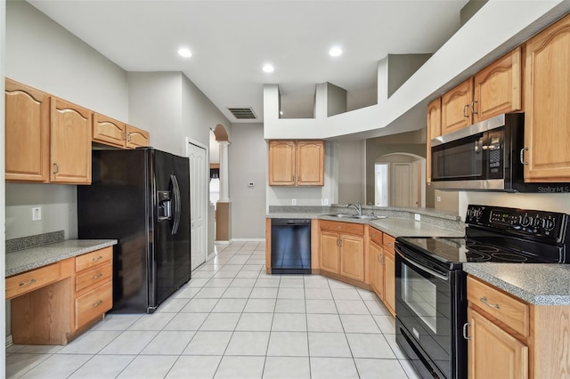 kitchen featuring arched walkways, light tile patterned flooring, a sink, visible vents, and black appliances