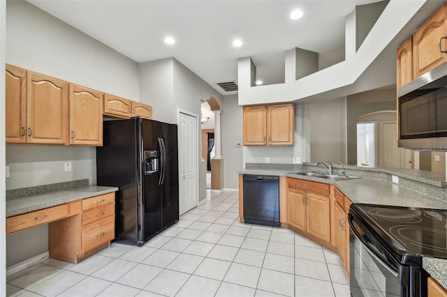 kitchen featuring arched walkways, light tile patterned floors, a sink, visible vents, and black appliances