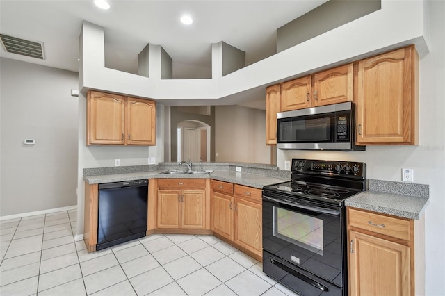 kitchen with visible vents, arched walkways, black appliances, a sink, and light tile patterned flooring