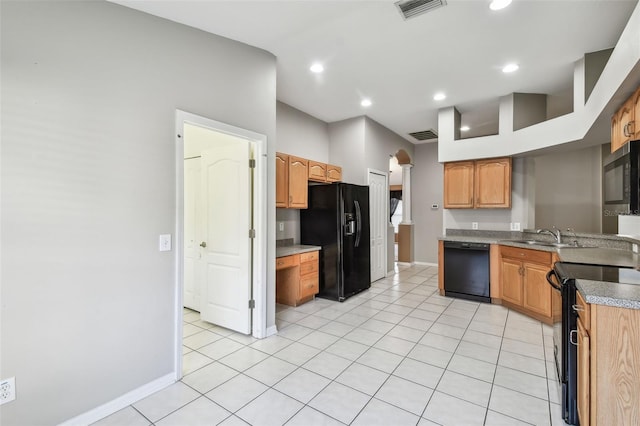 kitchen featuring visible vents, a sink, black appliances, and light tile patterned floors