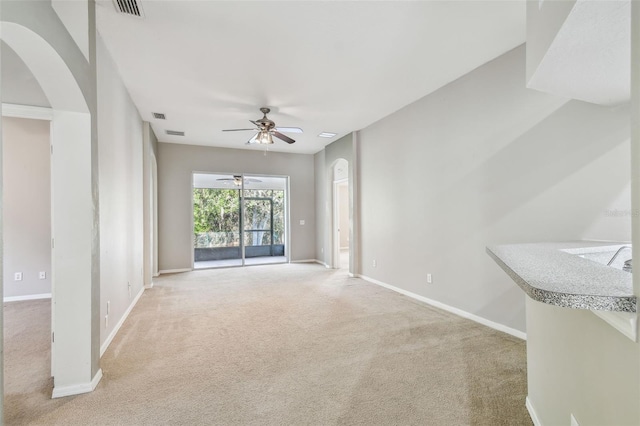 unfurnished living room featuring carpet flooring, visible vents, and baseboards