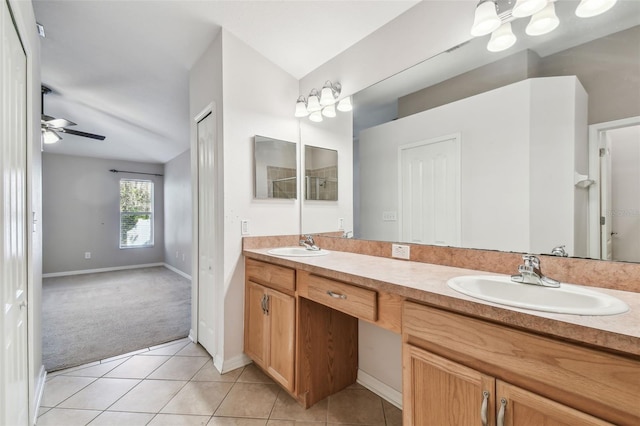 bathroom featuring double vanity, tile patterned flooring, a ceiling fan, and a sink