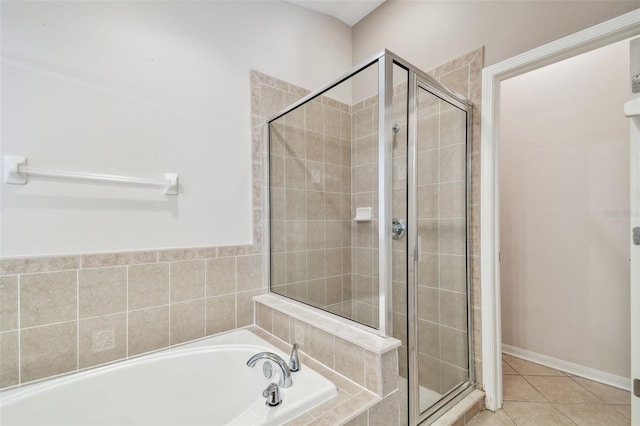 full bath with a garden tub, a shower stall, and tile patterned floors