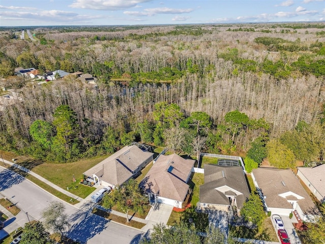 drone / aerial view with a residential view and a wooded view