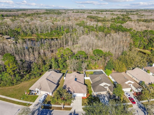 drone / aerial view with a forest view and a residential view