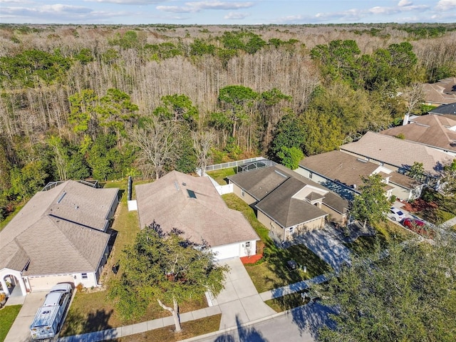 aerial view featuring a residential view and a wooded view