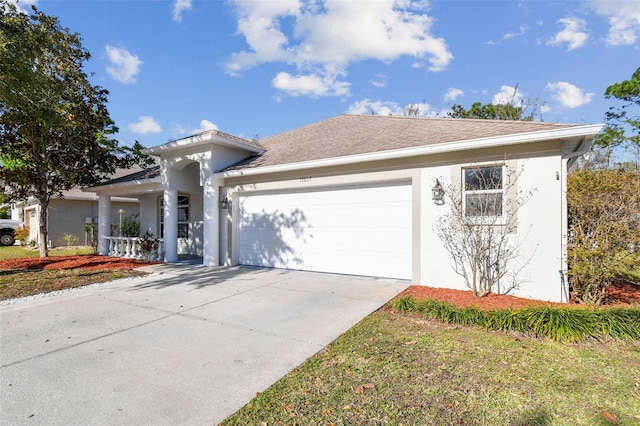 view of front facade featuring a garage, a shingled roof, concrete driveway, and stucco siding