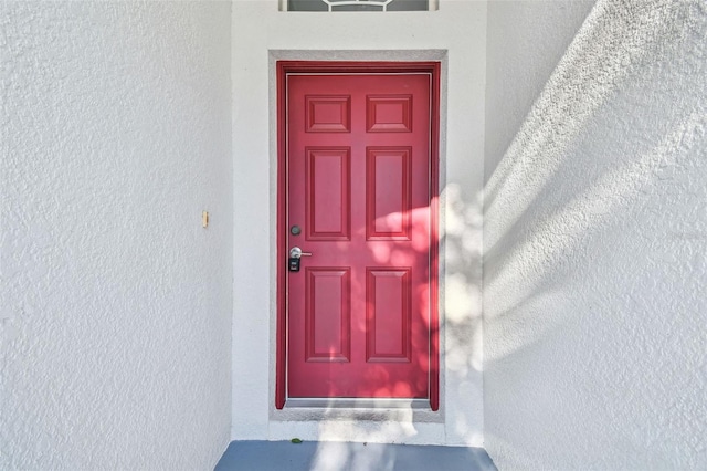 entrance to property with stucco siding