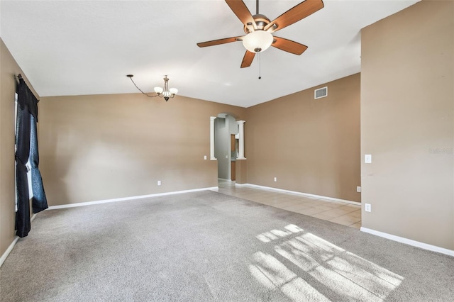 unfurnished room with light carpet, baseboards, visible vents, and arched walkways