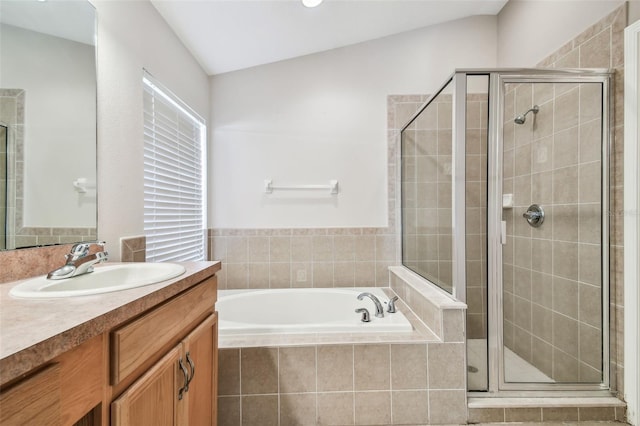 bathroom with a garden tub, a shower stall, and vanity