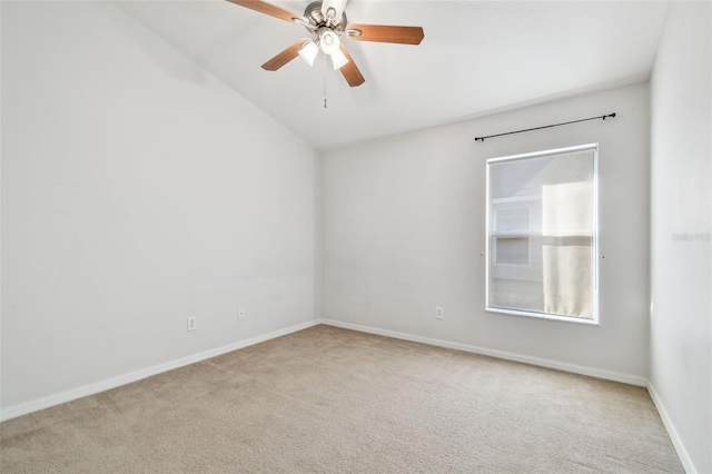 carpeted empty room featuring ceiling fan and baseboards