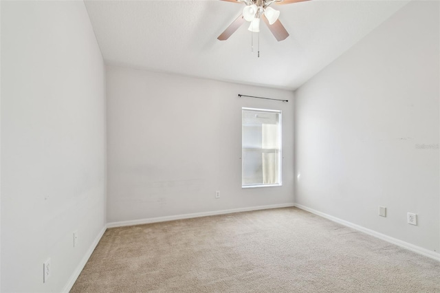 carpeted empty room featuring a ceiling fan and baseboards