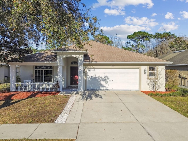 ranch-style home featuring a shingled roof, driveway, an attached garage, and stucco siding