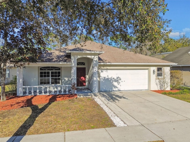 single story home featuring concrete driveway, a shingled roof, an attached garage, and stucco siding