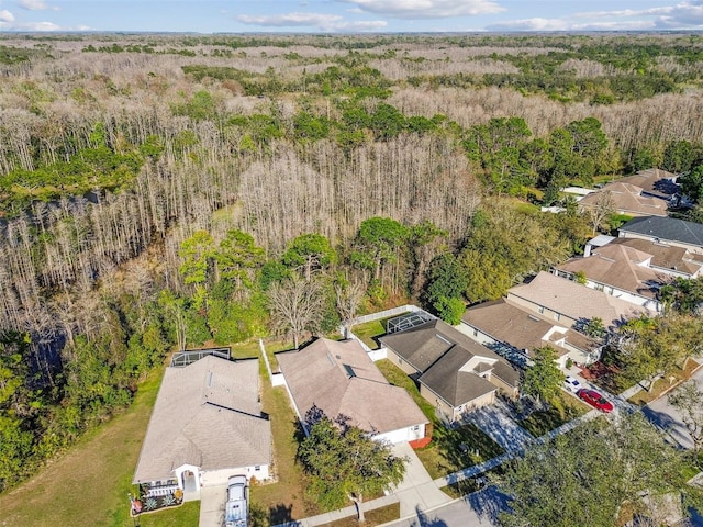 aerial view featuring a forest view and a residential view