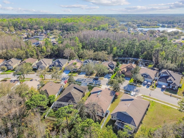 birds eye view of property featuring a forest view and a residential view