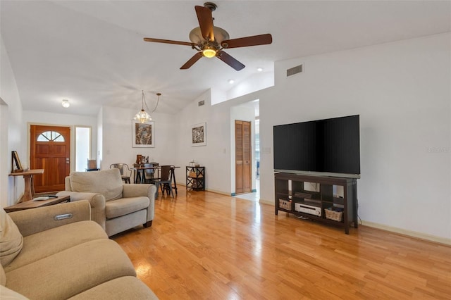 living room with visible vents, baseboards, light wood-style flooring, ceiling fan, and high vaulted ceiling