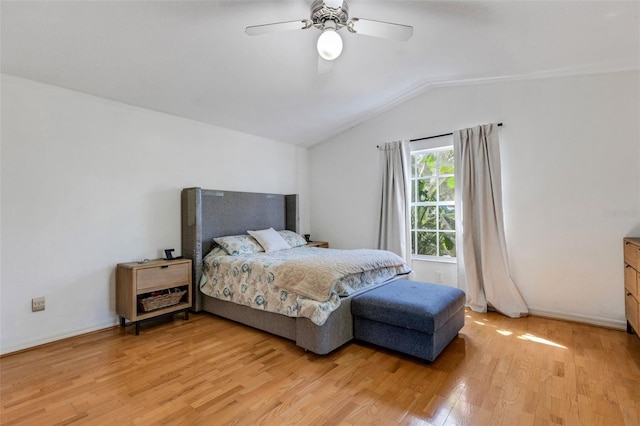 bedroom with light wood-type flooring, ceiling fan, lofted ceiling, and baseboards