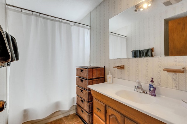 bathroom with shower / tub combo, tile patterned flooring, vanity, and wallpapered walls