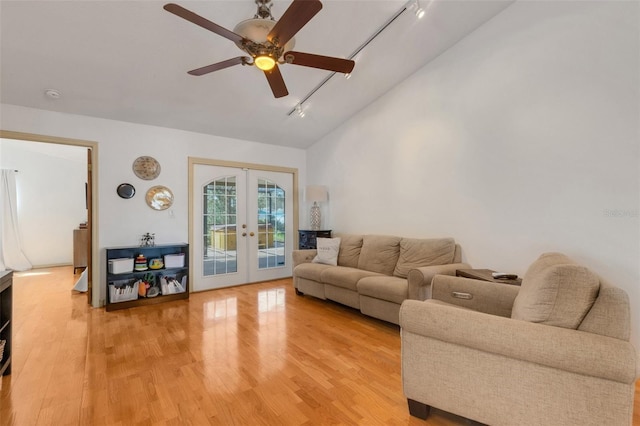 living area with ceiling fan, vaulted ceiling, french doors, light wood-type flooring, and rail lighting