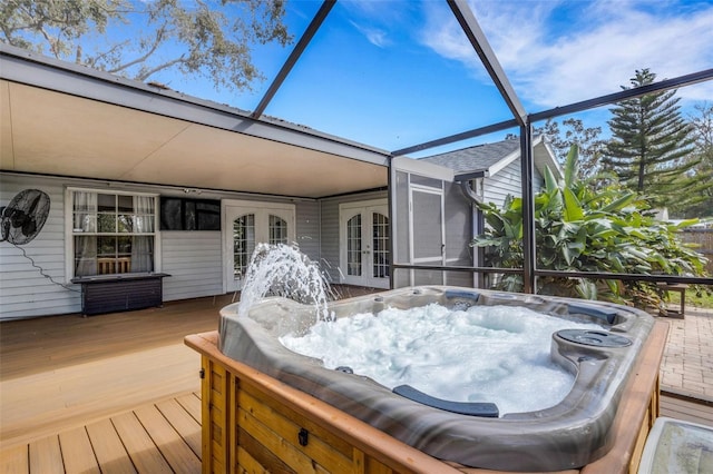 deck featuring a lanai, a hot tub, and french doors