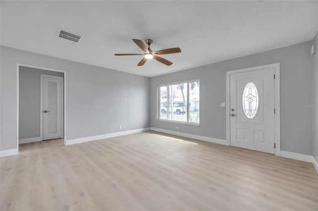 foyer featuring baseboards, visible vents, ceiling fan, and light wood finished floors