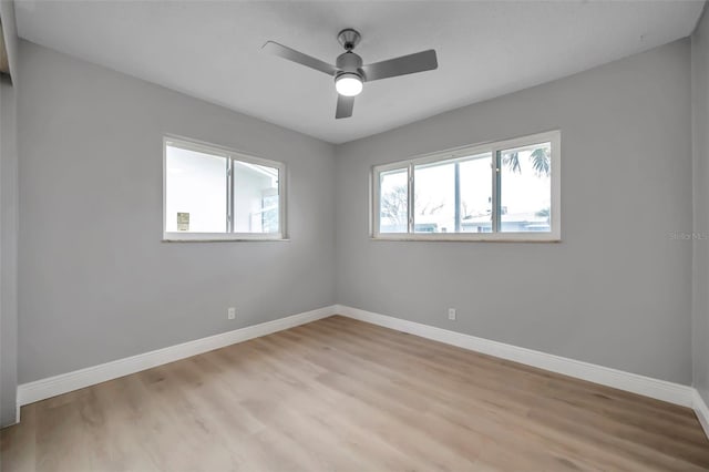 unfurnished room featuring light wood finished floors, a ceiling fan, and baseboards