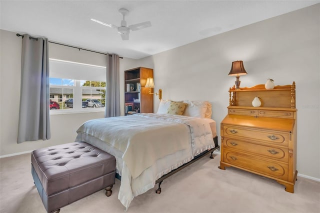 bedroom featuring ceiling fan, baseboards, and light colored carpet