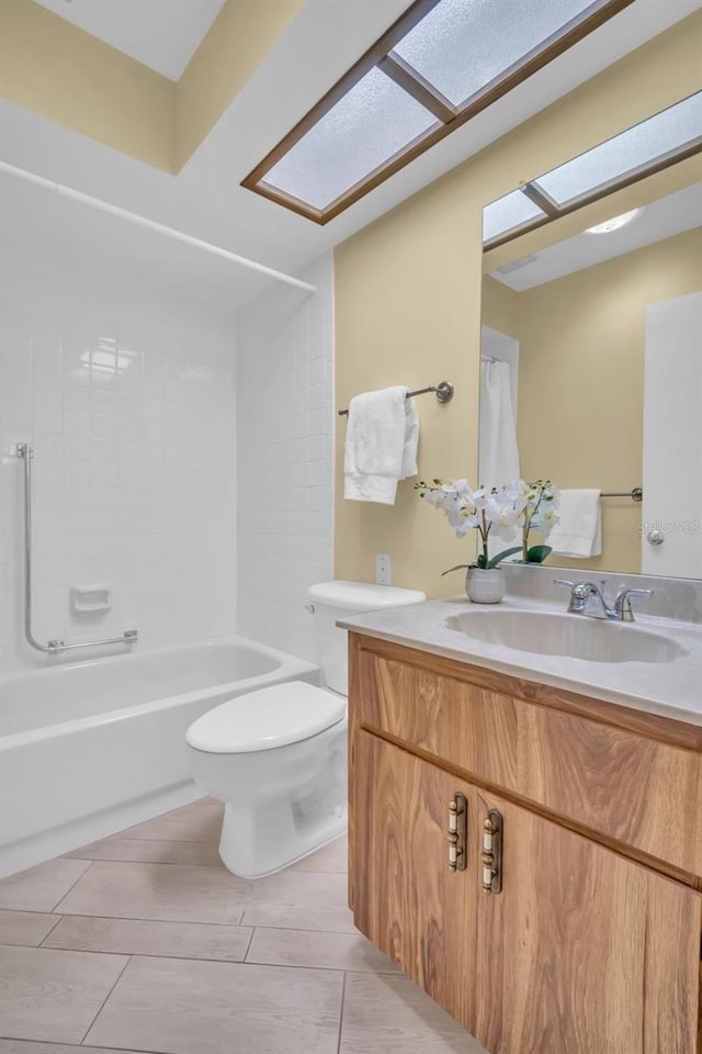 bathroom with toilet, a skylight, washtub / shower combination, and vanity