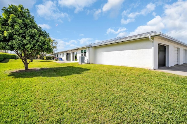 exterior space featuring central air condition unit and an attached garage