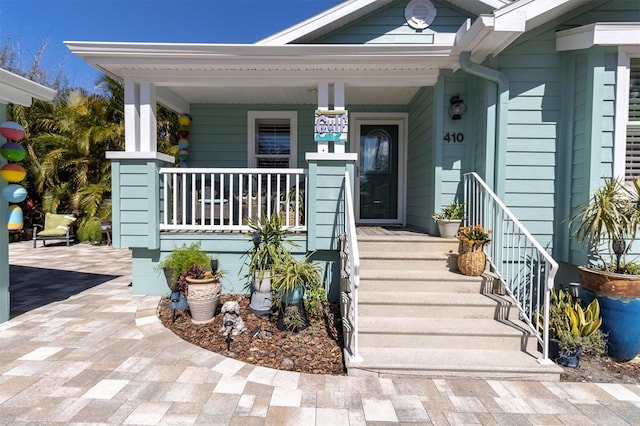 view of exterior entry with covered porch