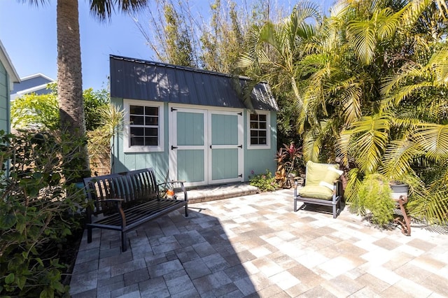 view of patio / terrace with a storage unit and an outbuilding