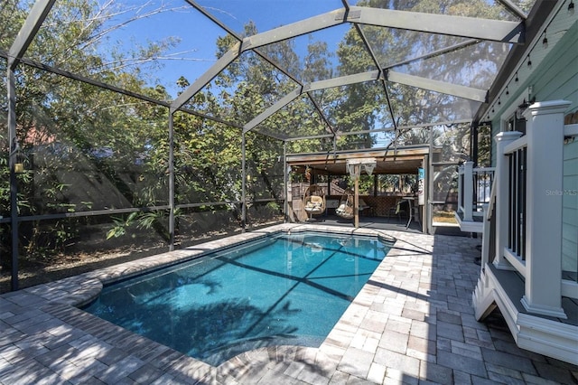 outdoor pool with a lanai and a patio