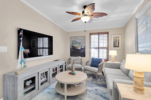 living area featuring a ceiling fan and crown molding