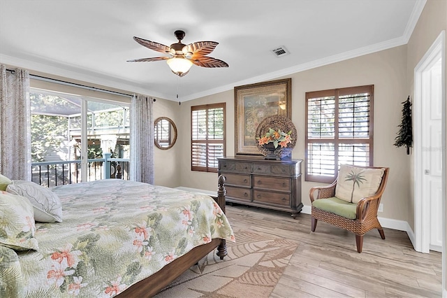 bedroom featuring ornamental molding, light wood finished floors, visible vents, and baseboards