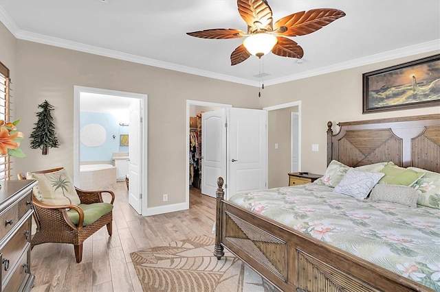 bedroom featuring light wood-style floors, ornamental molding, a walk in closet, and ensuite bathroom