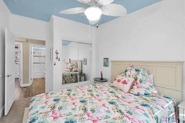 bedroom with ceiling fan and a closet