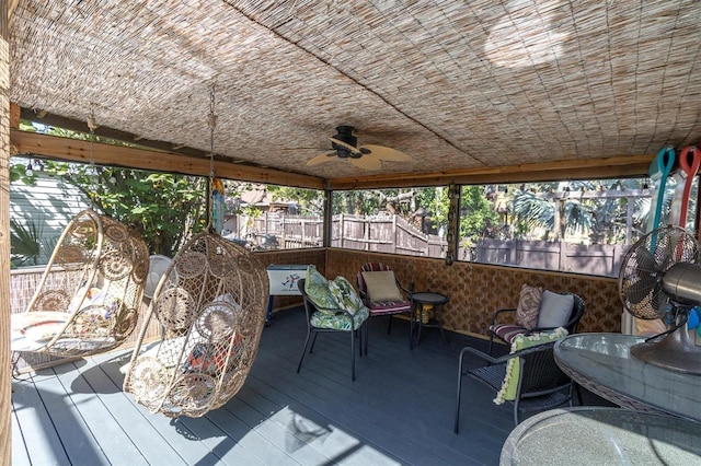 sunroom featuring brick ceiling and ceiling fan