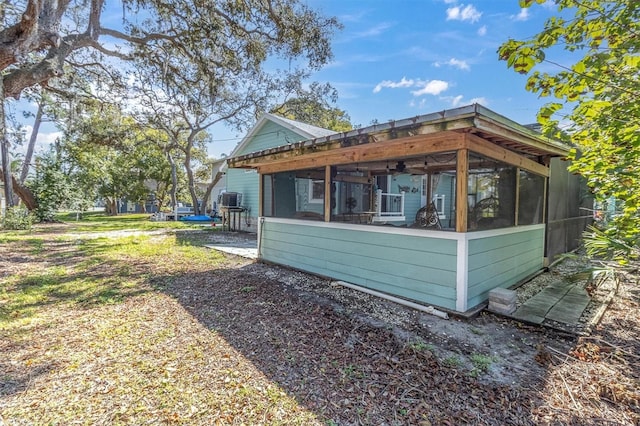 view of side of property featuring a sunroom