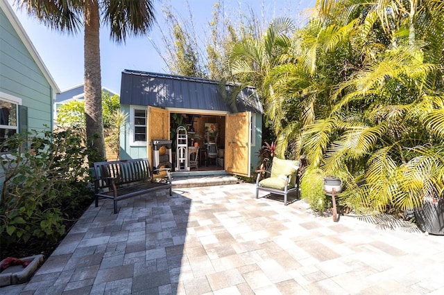 view of patio with an outbuilding