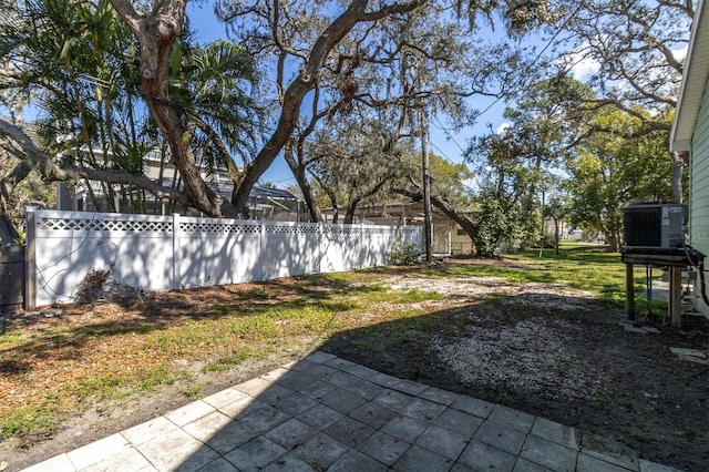 view of yard featuring fence and central air condition unit